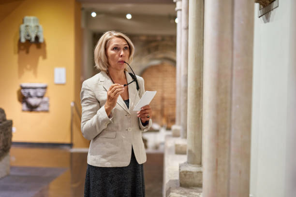 istock Woman Holding a Guide Inside a Museum 1278747063