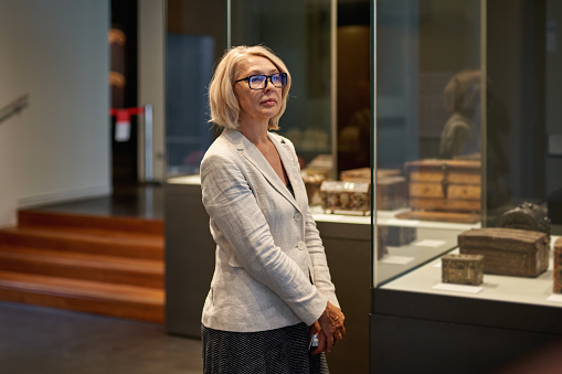 Woman exploring medieval expositions in museum