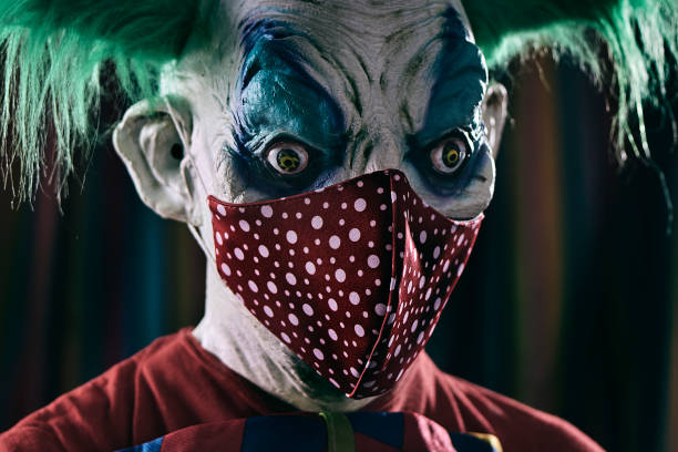 istock disturbing evil clown wearing a red face mask 1278750586