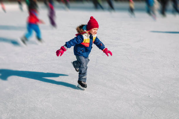 little girl skating in winter snow, seasonal sport for kids happy cute girl skating in winter snow, seasonal sport for kids ice skating photos stock pictures, royalty-free photos & images