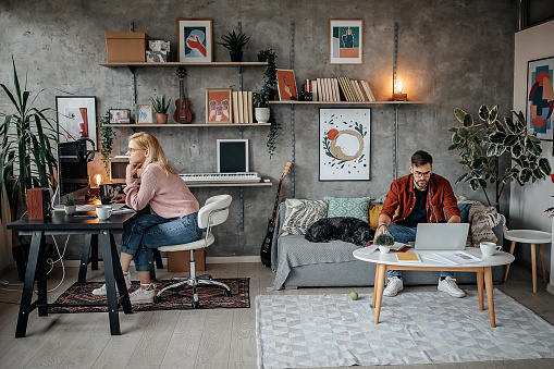 Young couple working from their home office during pandemic