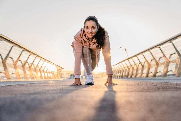istock Young female athlete is going to run on the bridge with sunlight behind 1278756285