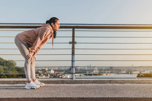 istock Young runner is having a break after jogging on the bridge. 1278756357