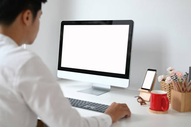 istock Cropped shot of young man planing his project on computer pc with white screen on white desk. 1278756635