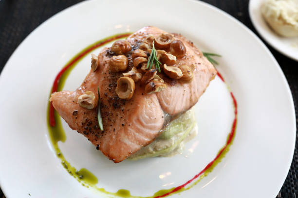 istock Trout with nuts and zucchini on white plate 1278757364