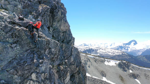 istock Female mountaineer climbs up mountain ridge 1278757856