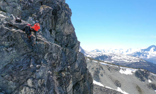 istock Female mountaineer climbs up mountain ridge 1278757944