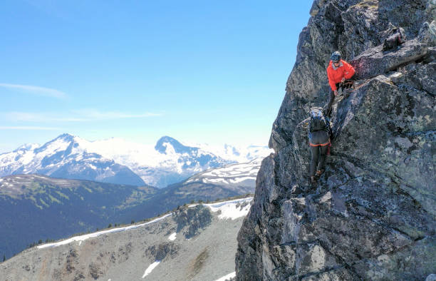 istock Female mountaineer climbs up mountain ridge 1278757958