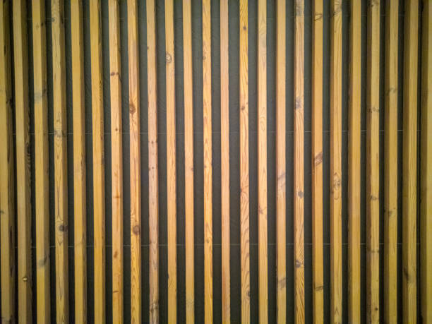 istock Seamless pattern of modern wall paneling with vertical wooden slats for background. Raw material of natural brown wood lath. 1278757977