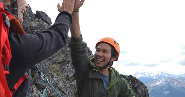 istock Mountaineer friends high-five on mountain ridge 1278758072