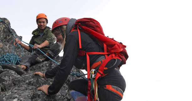 istock Female mountaineer climbs up mountain ridge 1278758100