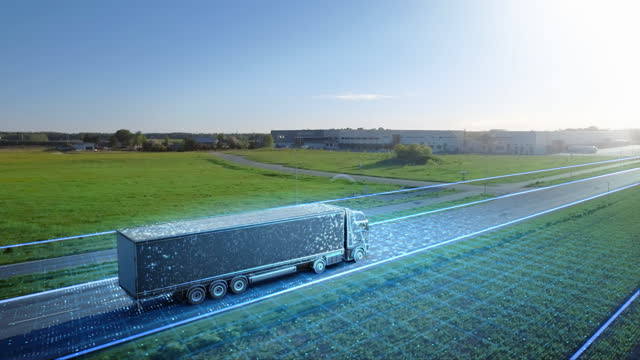 Advanced High-Tech Concept: Big Semi Truck with Cargo Trailer Drives on the Road is Transformed with Graphics Special Effects Into Digitalized Version of Futuristic Autonomous Truck. Aerial Drone Shot
