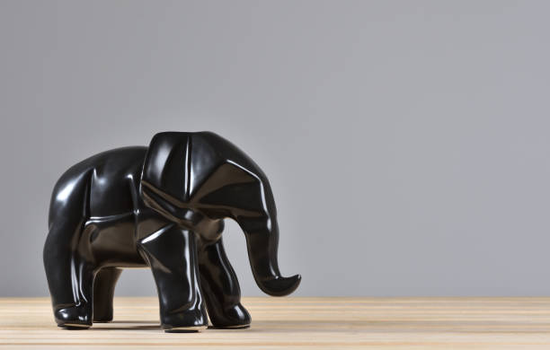 Figurine of a black elephant for decoration in geometry style.