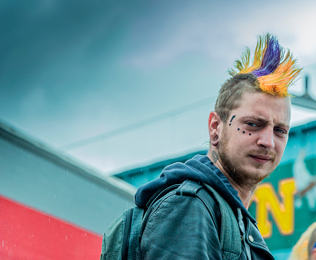 London Punk scene, portrait of one male punker, unsharp background at Camden Lock, London, UK.