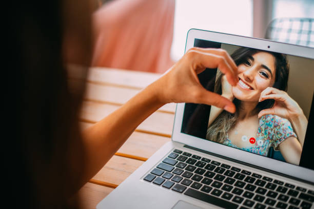 istock Friends Video Chatting and Making a Heart Shape With Their Hands Together 1278760532
