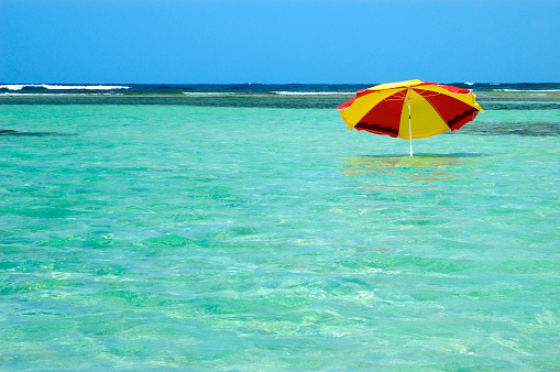 Beach umbrella inside a natural sea pool