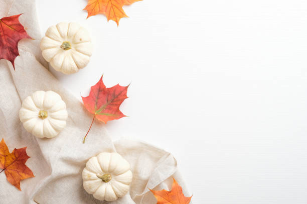 istock Autumn composition. Flat lay, top view maple leaves, pumpkin, beige fabric on white table. Season background. Autumn fall, thanksgiving concept. 1278763286