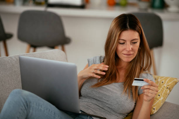 istock Young businesswoman at home makes a purchase on the Internet. 1278763563