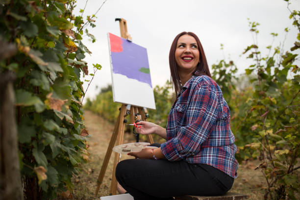 istock Creative woman painting in nature 1278764301