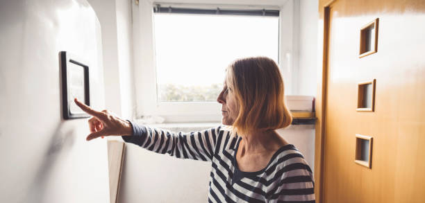 istock Woman changing the settings on the boiler 1278767084