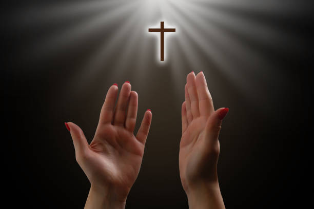 istock Woman's hands praying against a white background 1278767287