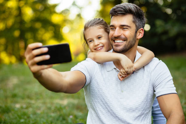 istock Father and daughter taking Selfie in the park 1278770782
