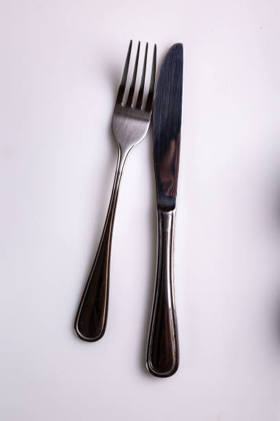 istock Cutlery knife and fork lie side on a white background. View from above. Vertical orientation. High quality photo 1278770821