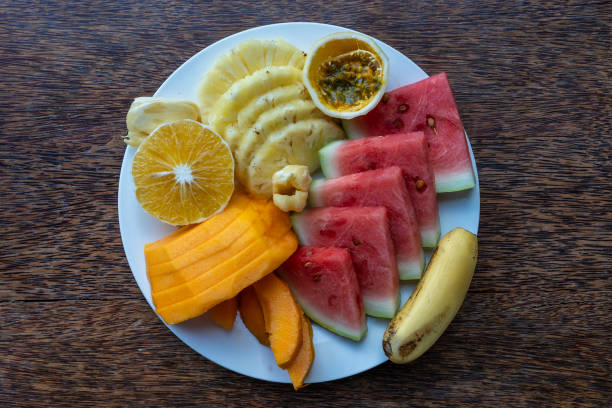 istock Tropical fruits on a breakfast plate, close up, top view 1278771004