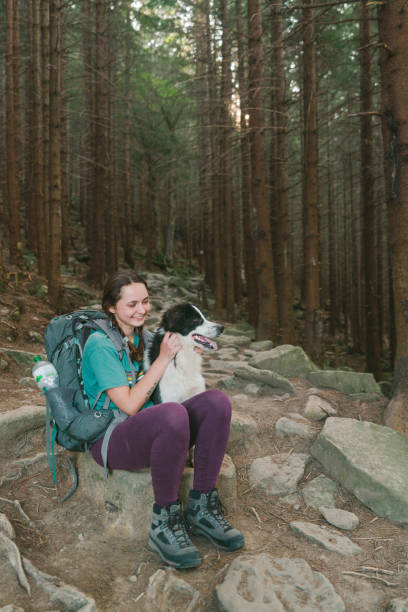 istock Woman hiking with dog in forest 1278771099