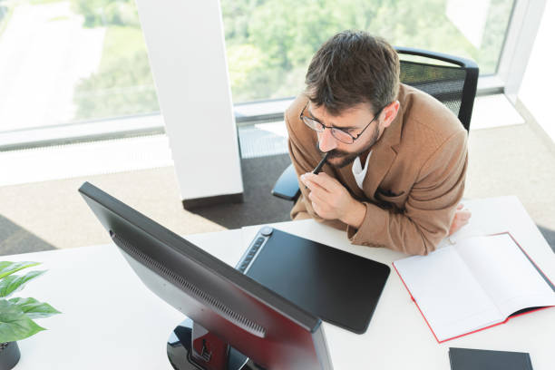 istock Thoughtful artist drawing something on graphic tablet at the office 1278771198