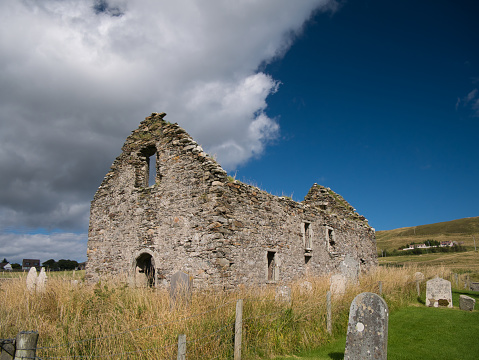 The ruins of Olnafirth Kirk and old gravestones in Voe, Shetland