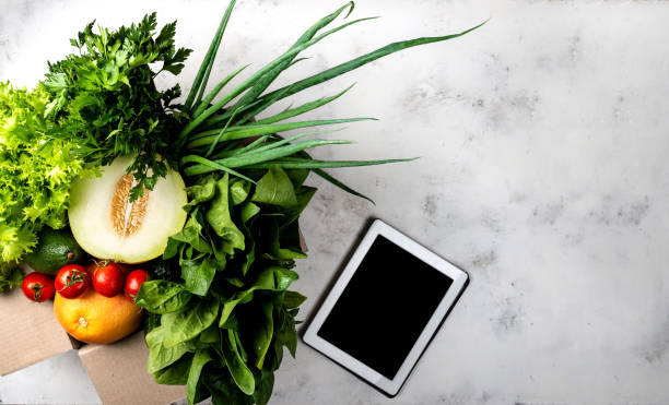 istock Box full of Different organic vegetables and greens and tablet computer. Top view. 1278774022