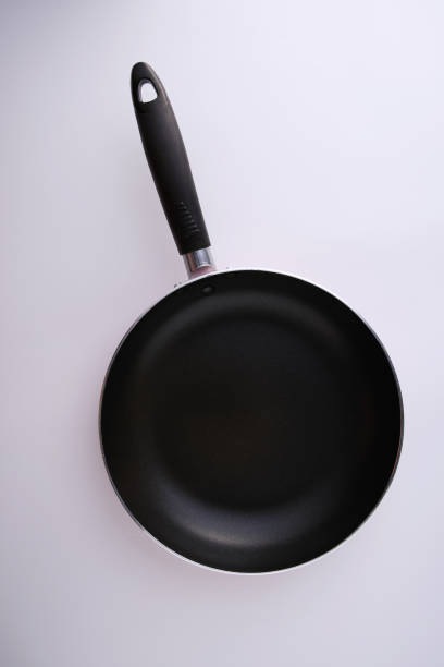 istock Empty nonstick frying pan isolated on white background closeup, top view 1278774195