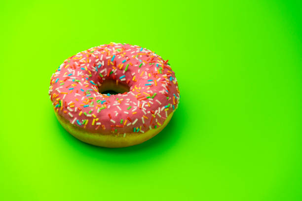 istock donut donuts on a green background close-up. isolate 1278774760
