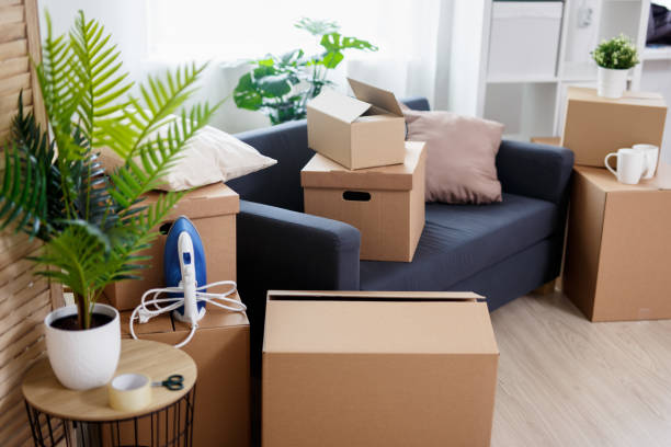 istock moving day - stack of brown cardboard boxes with belongings in new house 1278774986