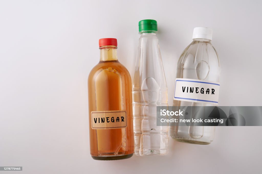 top view two bottles white vinegar and  bottle of apple cider vinegar Vinegar Stock Photo