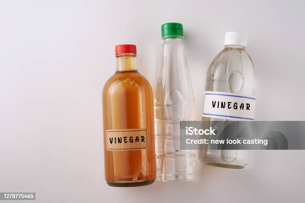 Top View Two Bottles White Vinegar And Bottle Of Apple Cider Vinegar Stock Photo - Download Image Now