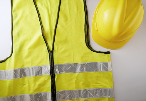 Yellow high visibility safety vest and helmet