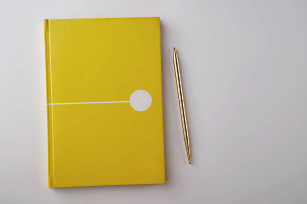 istock blank yellow color note book on white background 1278775540