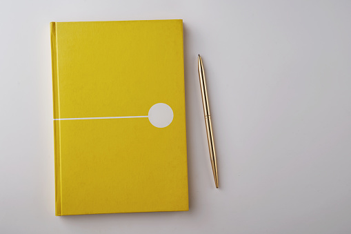 blank yellow color note book on white background