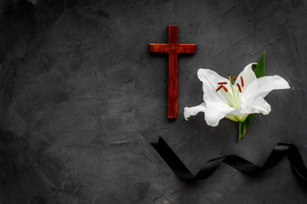 istock Funeral symbols. White lily with black ribbon, top view 1278776496
