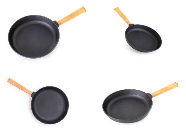 istock cast iron frying pan with removable wooden handle on white background isolate. Long lasting cooking pan for all types of stoves, domestic 1278777739