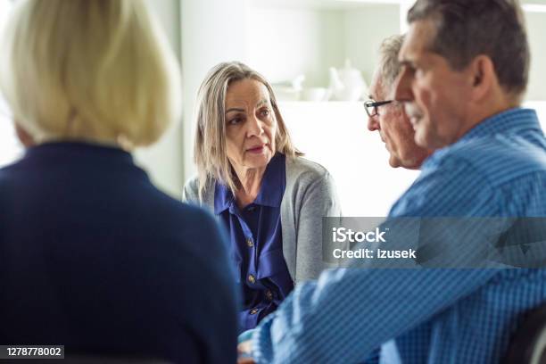 Worried Eldery Lady During Group Therapy Stock Photo - Download Image Now - Discussion, Meeting, Talking