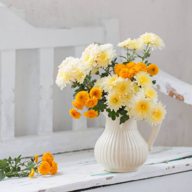 istock yellow chrysanthemums in jug on old  white wooden bench 1278778054