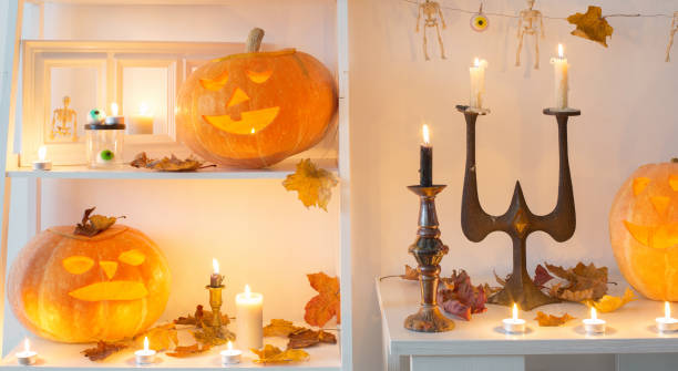 istock halloween pumpkins with candles on wooden table 1278778068