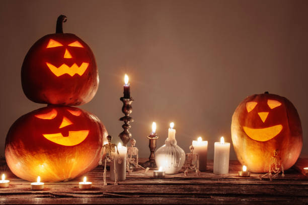istock halloween pumpkins with candles on wooden table 1278778072