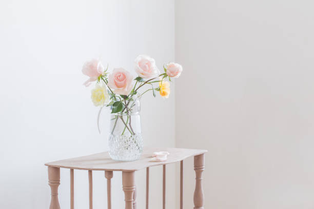 istock beautiful roses in glass jug on white background 1278778092