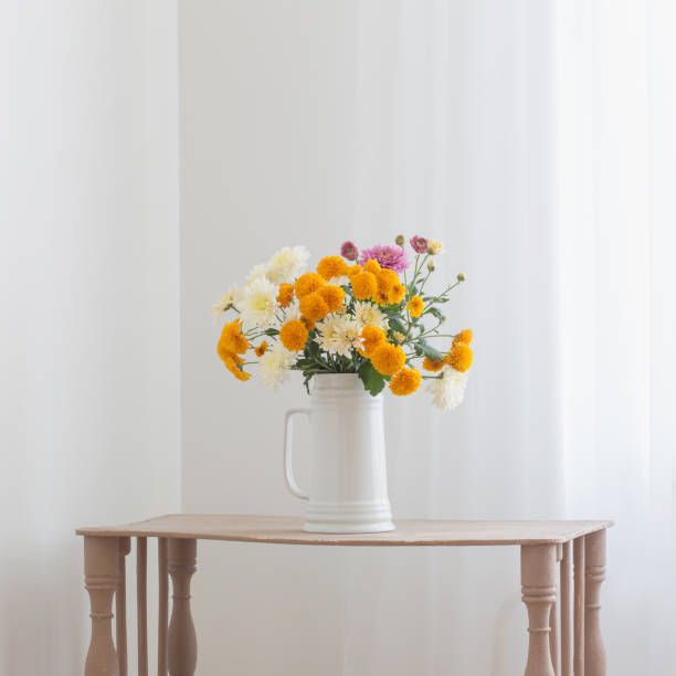 istock chrysanthemum flowers in white jug in white interior 1278778112