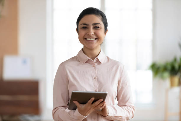istock Profile picture of smiling indian female employee using tablet 1278778770