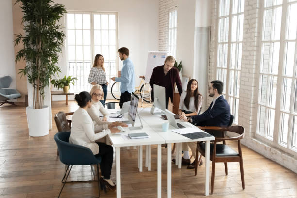 istock Diverse employee work cooperate in modern office together 1278778780